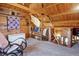 Inviting loft area showcasing rustic wood finishes and a cozy rocking chair, perfect for relaxation at 4840 N Templin Rd, Martinsville, IN 46151