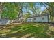 Spacious backyard featuring a wooden deck, green lawn, and shed at 4914 Indianola Ave, Indianapolis, IN 46205
