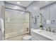 Well-lit bathroom featuring a shower-tub combination with sliding glass doors and a modern vanity with stainless steel fixtures at 4914 Indianola Ave, Indianapolis, IN 46205