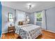 Primary bedroom with hardwood floors, neutral walls and two windows for natural light at 4914 Indianola Ave, Indianapolis, IN 46205