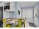 Eat-in kitchen features a breakfast bar with seating, white cabinets and stainless microwave at 4914 Indianola Ave, Indianapolis, IN 46205