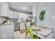 Bright kitchen features white cabinets, stainless appliances, and a breakfast bar at 4914 Indianola Ave, Indianapolis, IN 46205