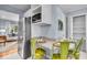 Cozy eat-in kitchen with stainless refrigerator and view into the living room at 4914 Indianola Ave, Indianapolis, IN 46205