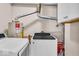 Laundry area featuring a washing machine and dryer, next to a water heater and some storage at 4914 Indianola Ave, Indianapolis, IN 46205