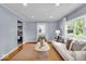 Bright living room featuring hardwood floors, a neutral sofa, stylish decor and lots of natural light at 4914 Indianola Ave, Indianapolis, IN 46205