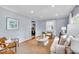 Bright living room featuring hardwood floors, a neutral sofa, stylish decor and lots of natural light at 4914 Indianola Ave, Indianapolis, IN 46205
