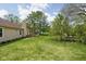 Large backyard featuring mature trees and a brick patio at 504 Countryside Dr, Lebanon, IN 46052
