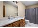 Bathroom with wood vanity, sink, mirror, and shower/tub combination at 504 Countryside Dr, Lebanon, IN 46052