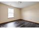 Bedroom featuring dark wood-look vinyl floors and a window allowing natural light at 504 Countryside Dr, Lebanon, IN 46052