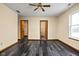 Bedroom with wood floors, neutral paint, ceiling fan and ensuite bathroom at 504 Countryside Dr, Lebanon, IN 46052