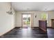 A dining area featuring dark floors, sliding glass doors, and natural light at 504 Countryside Dr, Lebanon, IN 46052