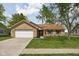 Charming single-story brick home featuring an attached two-car garage and a well-manicured lawn at 504 Countryside Dr, Lebanon, IN 46052