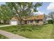 A charming single-story brick home with a well-maintained lawn and mature tree in the yard at 504 Countryside Dr, Lebanon, IN 46052