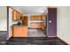Eat-in kitchen featuring wood cabinetry, tiled floor, and stainless steel refrigerator at 504 Countryside Dr, Lebanon, IN 46052