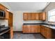 Kitchen featuring tile floor, wood cabinets, stainless appliances, and natural light at 504 Countryside Dr, Lebanon, IN 46052