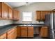 Kitchen featuring tile floors, natural light, wood cabinetry, and stainless steel refrigerator at 504 Countryside Dr, Lebanon, IN 46052