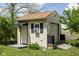 Exterior of the shed with an awning, black shutters, garage door, and dual rain barrels at 504 Countryside Dr, Lebanon, IN 46052