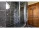 Bathroom featuring a tile shower with glass door and wood door at 504 Countryside Dr, Lebanon, IN 46052