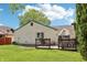 Backyard featuring a patio, grassy area, and lush green trees at 5323 Shefford Ct, Indianapolis, IN 46254