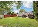 Grassy backyard with patio, privacy fence, and leafy green trees at 5323 Shefford Ct, Indianapolis, IN 46254