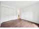 Bedroom featuring hardwood floors, a window, and double door closets at 5323 Shefford Ct, Indianapolis, IN 46254