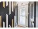 Stylish entryway with decorative wall accents, white door with oval glass, and tiled flooring at 5323 Shefford Ct, Indianapolis, IN 46254