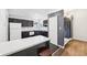 Modern kitchen featuring dark cabinets, white appliances, and stylish breakfast bar at 5323 Shefford Ct, Indianapolis, IN 46254