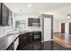 Open kitchen with dark cabinetry, tile backsplash, and updated appliances at 5323 Shefford Ct, Indianapolis, IN 46254