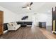 Bright living room with a ceiling fan, neutral-colored walls, and comfortable seating arrangement at 5323 Shefford Ct, Indianapolis, IN 46254
