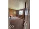 Cozy bedroom featuring a large window for natural light and neutral carpet at 5327 Traditions Dr, Indianapolis, IN 46235