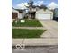 Exterior shot of a 2-story home with a 2 car garage and an advertisement sign on the lawn at 5327 Traditions Dr, Indianapolis, IN 46235