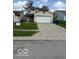 Exterior view of a two-story home with a two-car garage and a well-manicured front lawn at 5327 Traditions Dr, Indianapolis, IN 46235