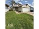 Charming two-story home with a well-maintained lawn, two car garage, and inviting front entrance at 5327 Traditions Dr, Indianapolis, IN 46235