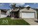 Two-story home with a two car garage and a well-maintained front lawn at 5327 Traditions Dr, Indianapolis, IN 46235