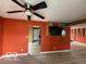 Bright living room showcasing wood-look floors, ceiling fan, and painted accent wall at 5327 Traditions Dr, Indianapolis, IN 46235