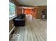 Inviting living room with wood-look flooring and a large window for natural light at 5327 Traditions Dr, Indianapolis, IN 46235