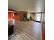 Spacious living room with wood-look floors, open staircase, and neutral paint at 5327 Traditions Dr, Indianapolis, IN 46235