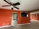 Living room featuring wood-look floors, ceiling fan, and unique wall decor at 5327 Traditions Dr, Indianapolis, IN 46235