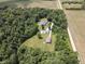 Aerial view of property showing the home and outbuildings surrounded by trees at 5607 E 500 N, Greenfield, IN 46140