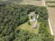 Aerial view of property showing the home and outbuildings surrounded by trees at 5607 E 500 N, Greenfield, IN 46140