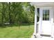 Backyard view featuring a white door with windows and a partially fenced yard at 5607 E 500 N, Greenfield, IN 46140