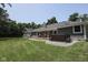 Expansive backyard with a hot tub and deck, providing a private and relaxing outdoor space with trees at 5607 E 500 N, Greenfield, IN 46140