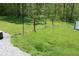 View of the backyard with a grassy lawn surrounded by a fence and trees at 5607 E 500 N, Greenfield, IN 46140
