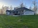 Large, green backyard with a hot tub and deck area, ideal for enjoying the outdoors at 5607 E 500 N, Greenfield, IN 46140