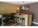 Finished basement bar area with stone accents, pendant lights, and seating for three at 5607 E 500 N, Greenfield, IN 46140