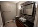 Bathroom with stone accent wall, granite vanity, unique sink, and tile floor at 5607 E 500 N, Greenfield, IN 46140