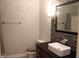 Bathroom features a stone accent wall, modern sink, and decorative wall hangings above the toilet at 5607 E 500 N, Greenfield, IN 46140