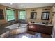 Bathroom featuring soaking tub, granite countertop, double sinks, and decorative mirrors at 5607 E 500 N, Greenfield, IN 46140