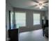 Neutral bedroom featuring carpet, closet, windows, and modern ceiling fan at 5607 E 500 N, Greenfield, IN 46140