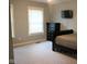 Bright bedroom with neutral walls and carpet and a large window with blinds allowing natural light at 5607 E 500 N, Greenfield, IN 46140
